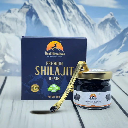 Shilajit box image with spoon from front with bluerred himalayan background