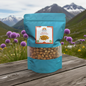 Turquoise package of Himalayan Knoblauch Garlic on a wooden surface with a mountainous background